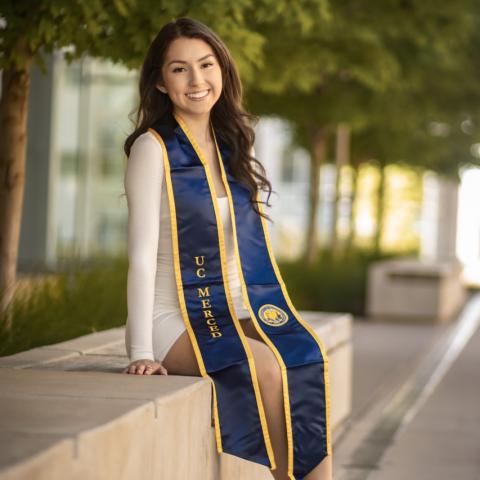 Image of Erika in her UC Merced Graduation Sash